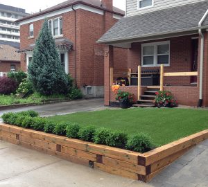 Neat and tidy. Nice retaining wall made with timbers and artificial grass 