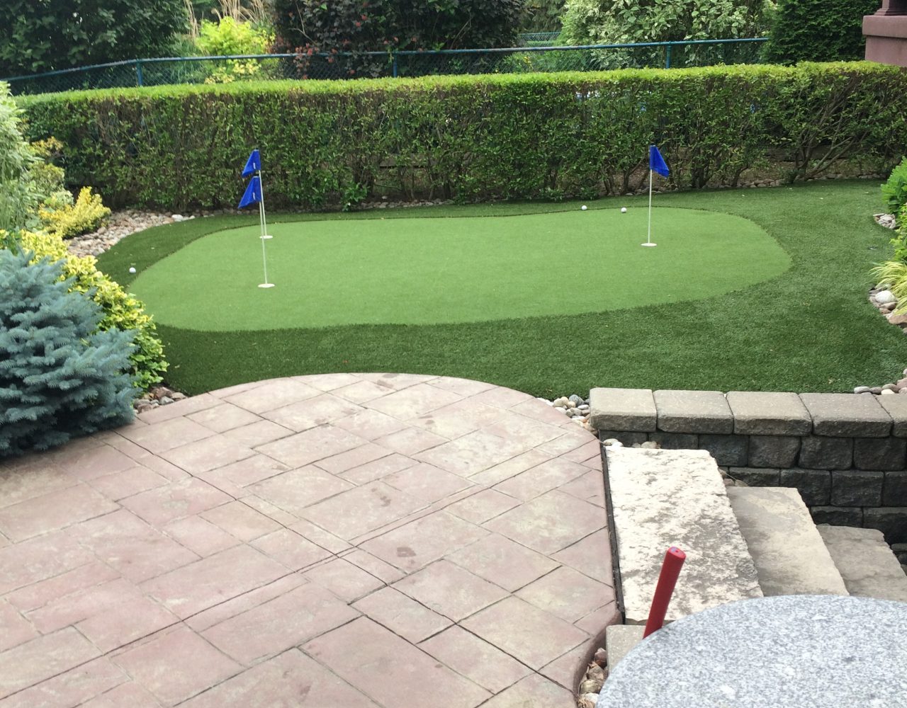 Two hole synthetic putting green for challenging up and downhill putts