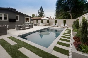 Beautiful Swimming pool with artificial grass softening the look