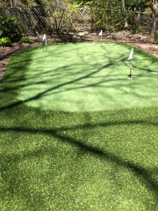 Golf green tucked into well garden landscaping 