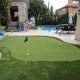 Synthetic 4- hole green compilments this active backyard