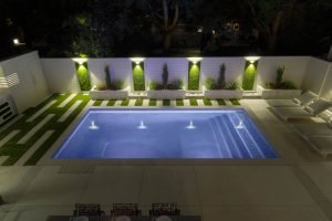 artificial grass walls lit with night lighting 