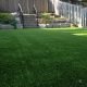Artificial grass meets upper tier stairs and retaining wall