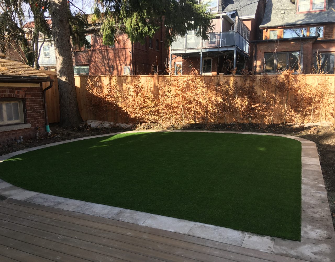 artificial grass framed with flagstone