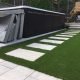 Above ground pool, flagstone path and artificial grass make for a lovely backyard