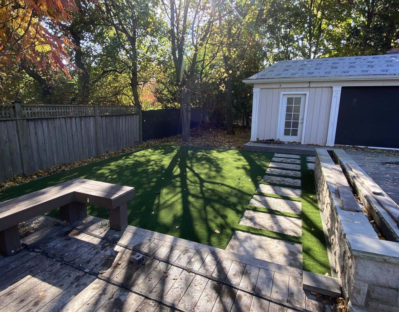 Cedar deck paver path bordered with grass