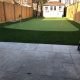 4 hole golf green in balance with fencing & white shed