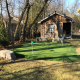 A rustic cabin with large armour stone & golf green