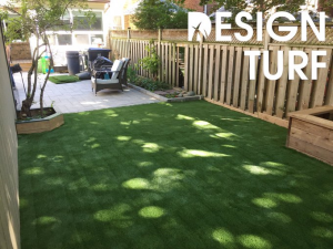 perfect yard for artificial grass against fencing and garden containers